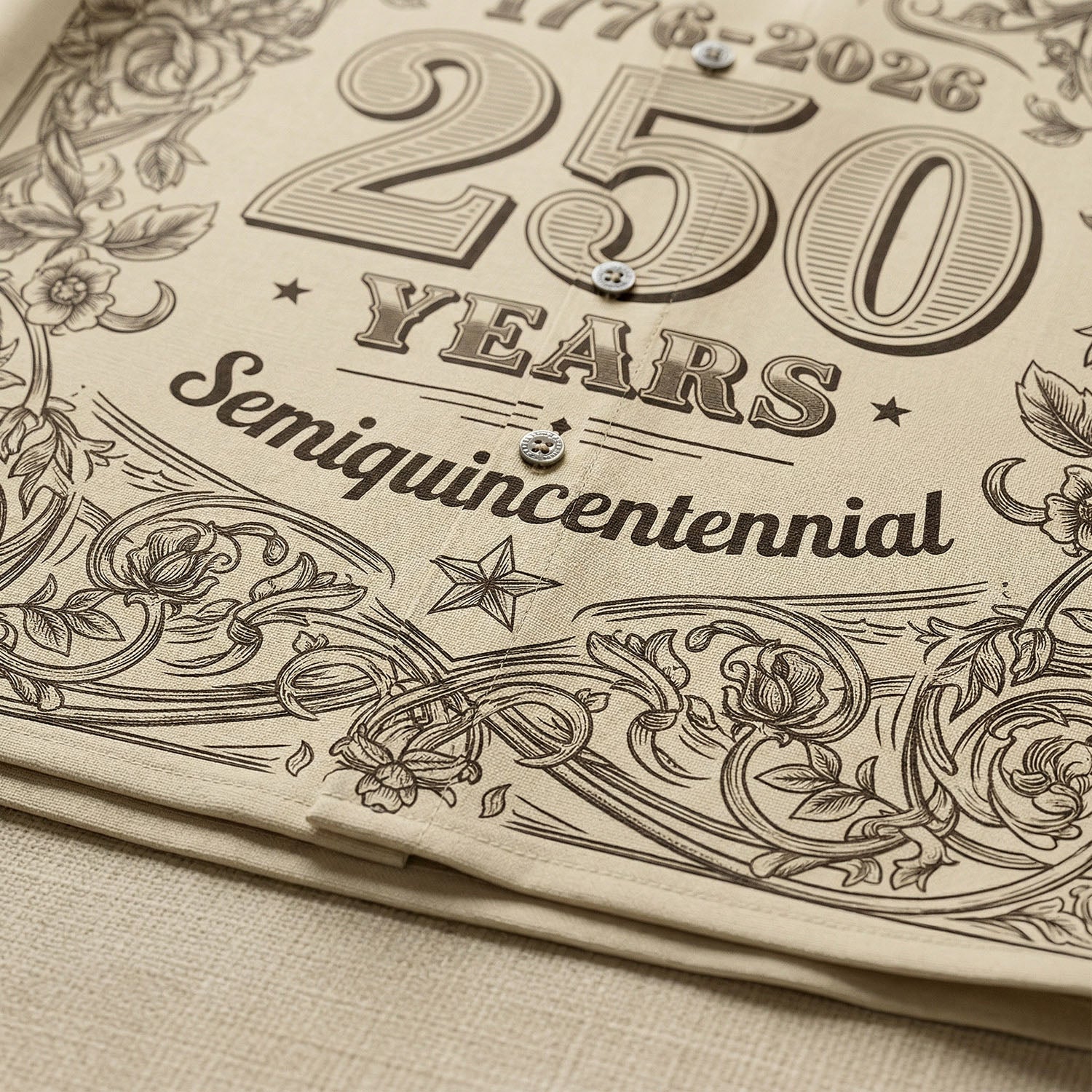 Macro close-up showing the high-quality fabric texture and detailed engraved "250 Years" typography and floral patterns on the cream patriotic shirt.
