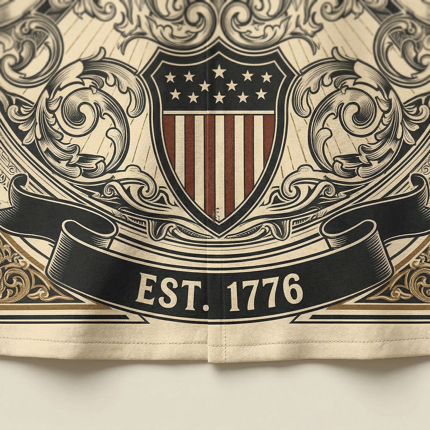 Macro close up shot of the patriotic shield icon and Est 1776 banner on the vintage cream Liberty Bell Hawaiian shirt