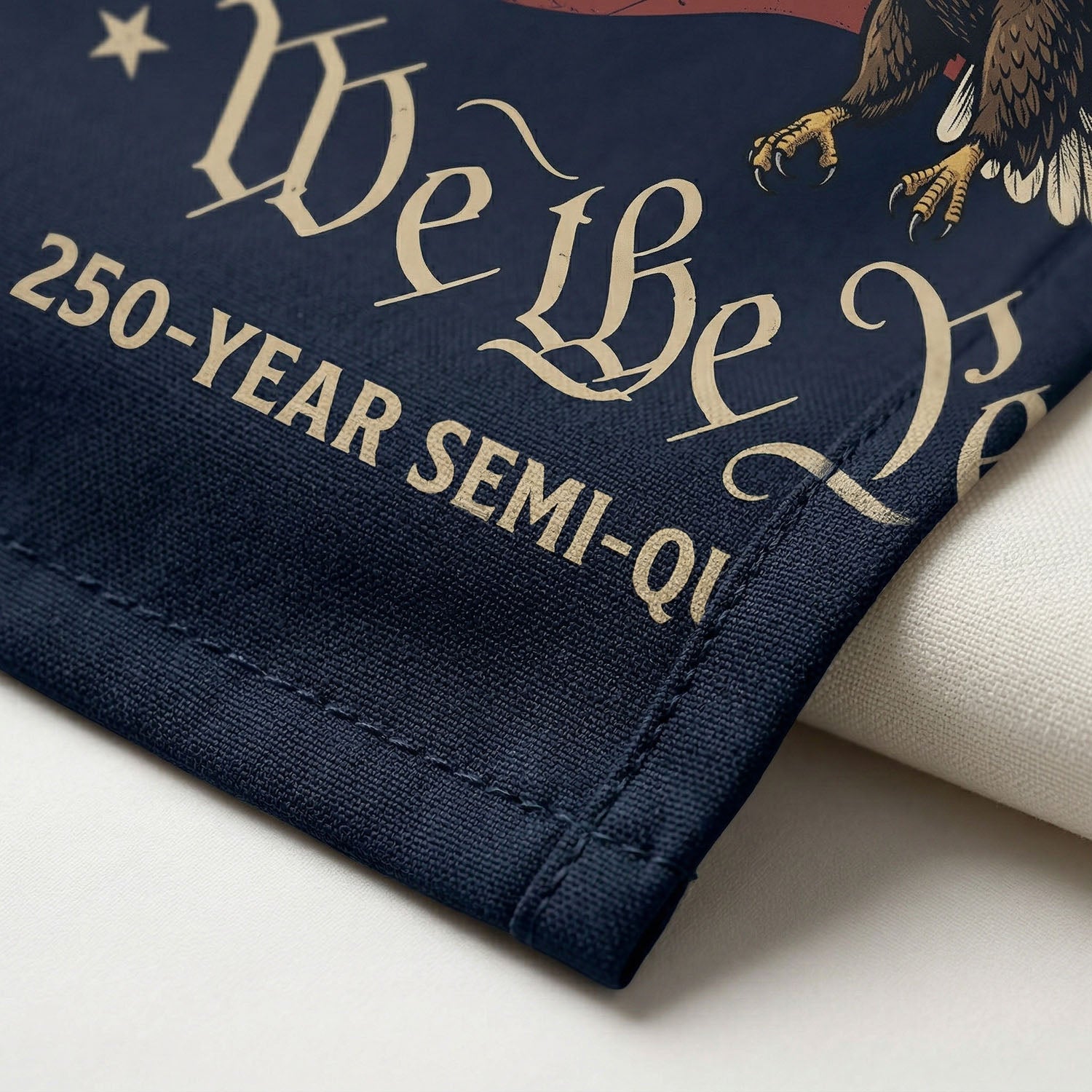 Macro close up of the high quality print showing the patriotic shield icon and Est 1776 banner on the vintage cream Liberty Bell shirt