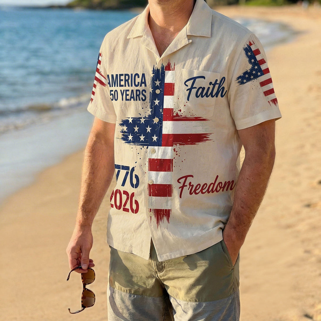 Front view of a cream-colored patriotic Hawaiian shirt featuring an American flag cross design with "Faith" and "Freedom" text for the 250th anniversary.