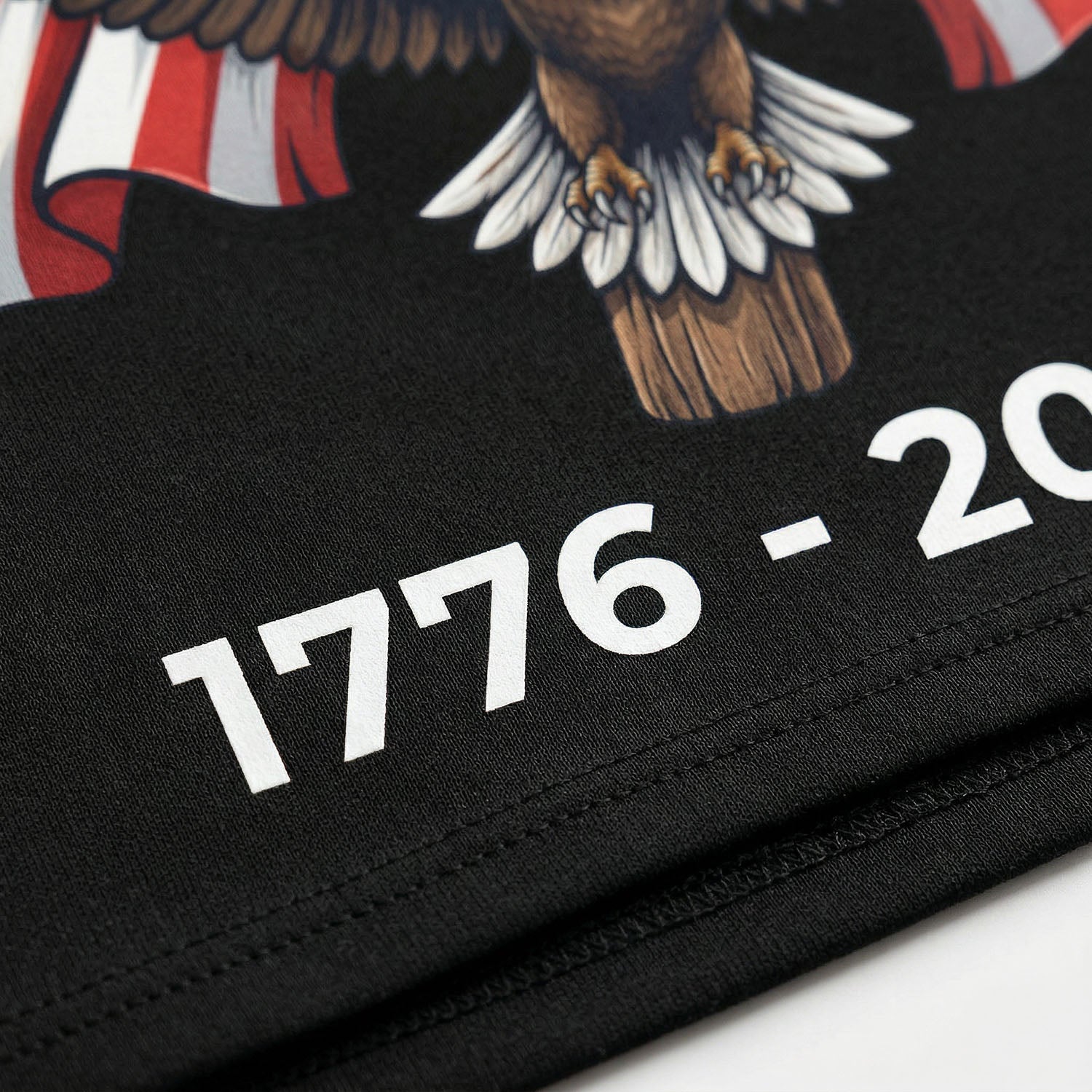 Macro shot of the high-quality white "1776-2026" print on the black fabric hem, highlighting the sharp details and durable material.