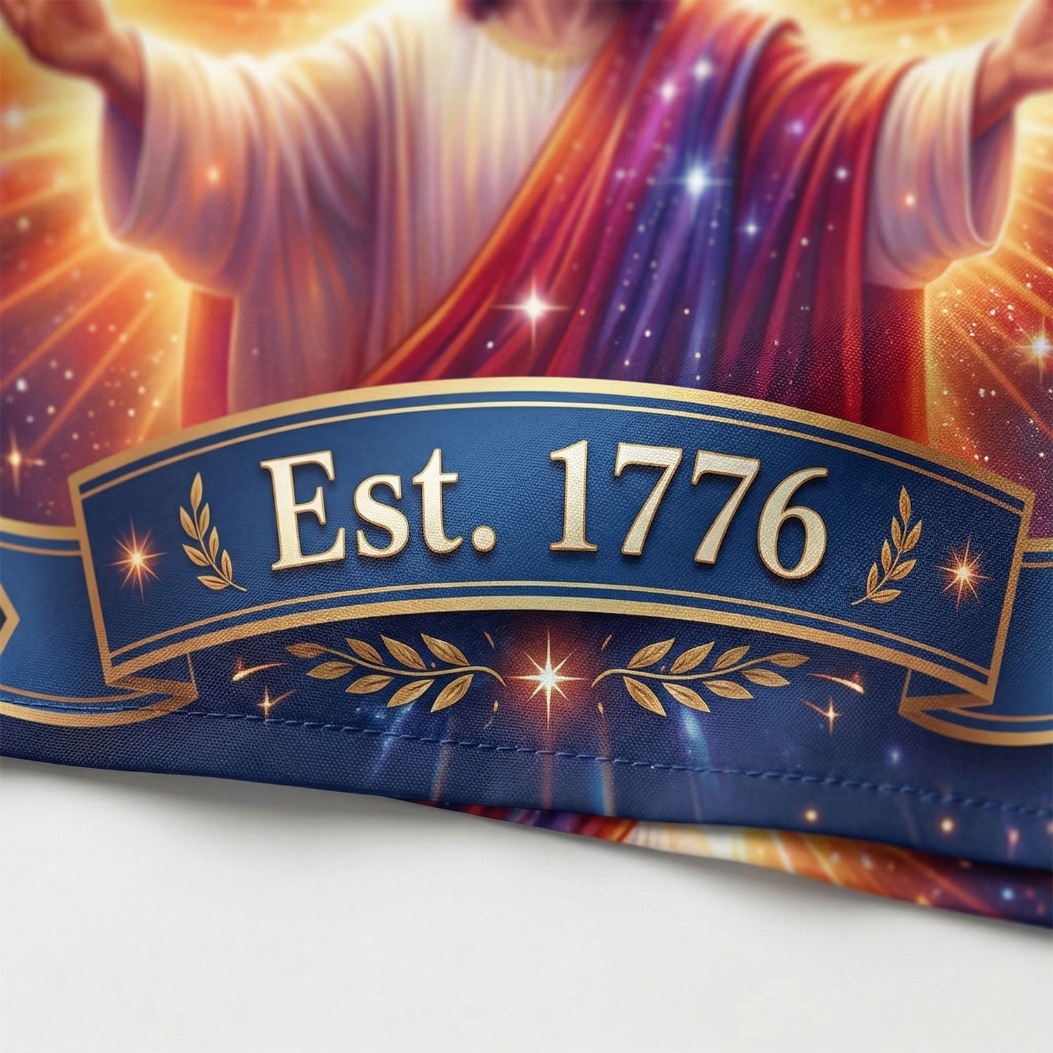 Close-up of the high-definition print on the shirt hem showing "Est. 1776" with golden laurel leaves on a navy blue background.