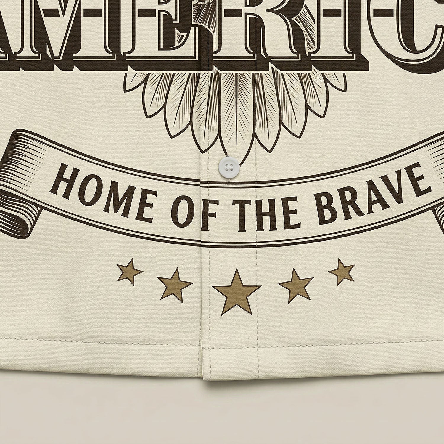 Close-up shot of the high-quality hem print showing "Home of the Brave" and decorative stars on the vintage cream shirt.
