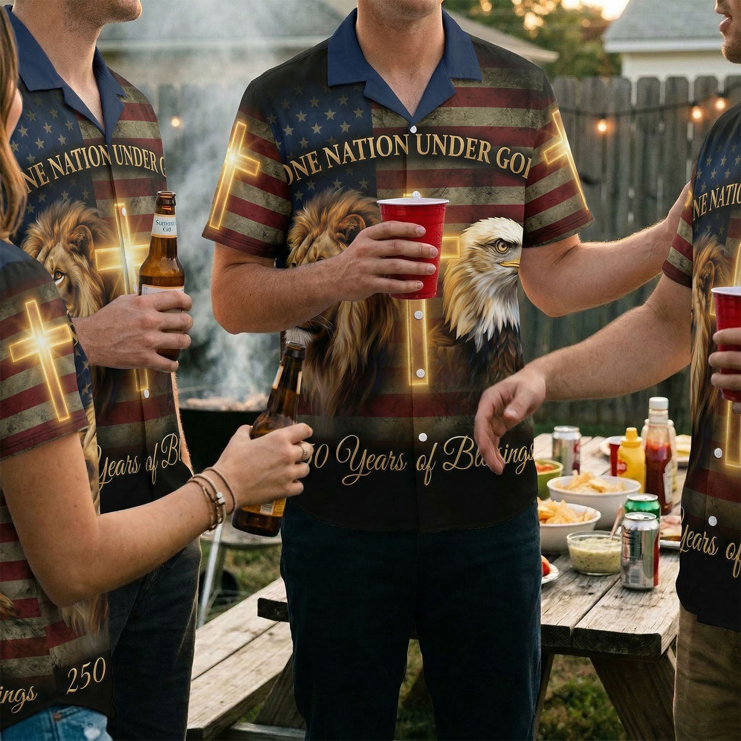 A joyful group of people wearing matching 1776-2026 American Heritage shirts at an outdoor festive event, symbolizing unity and freedom.