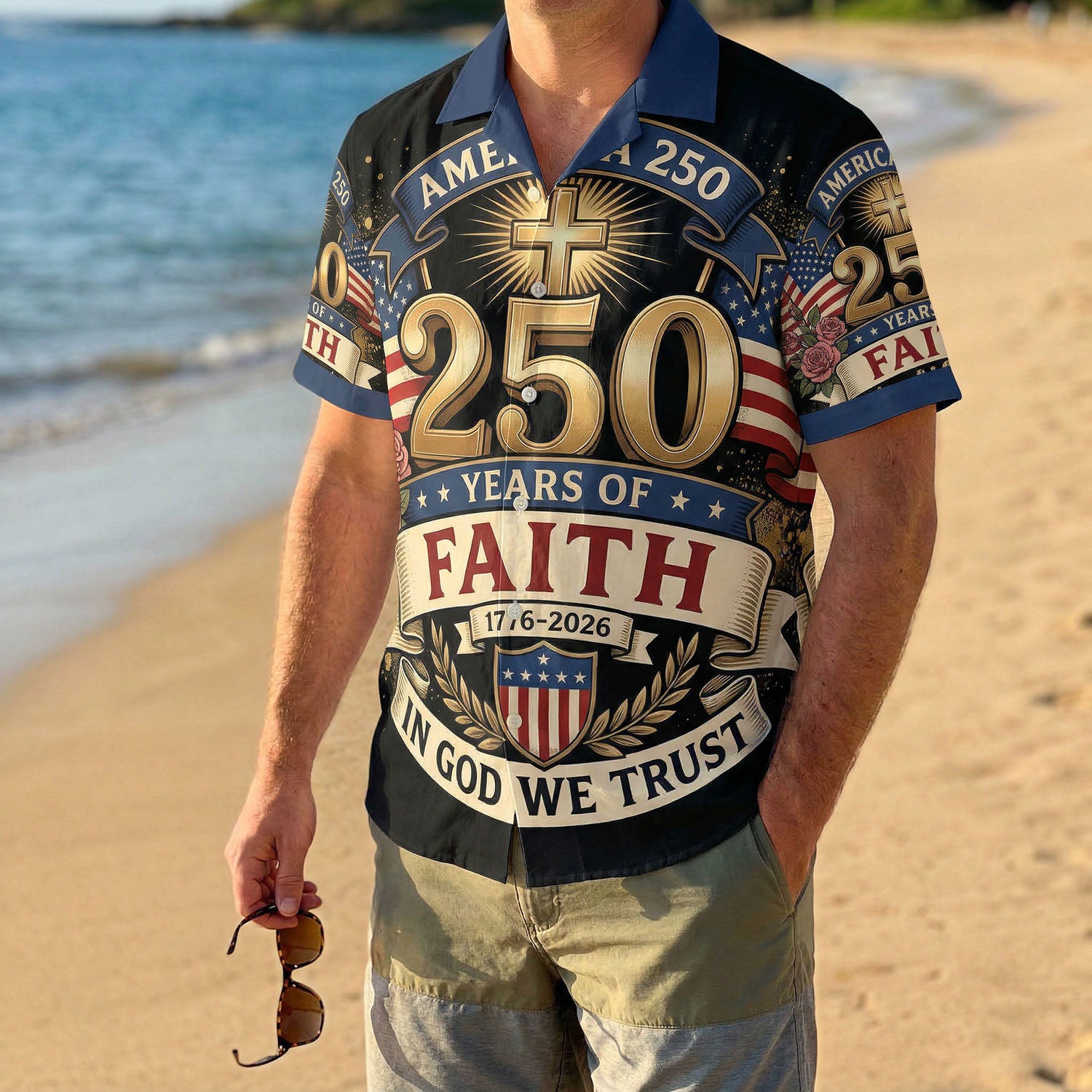 A male model wearing the vintage One Nation Under God Aloha shirt on a sunny beach, showcasing a meaningful and patriotic summer look.