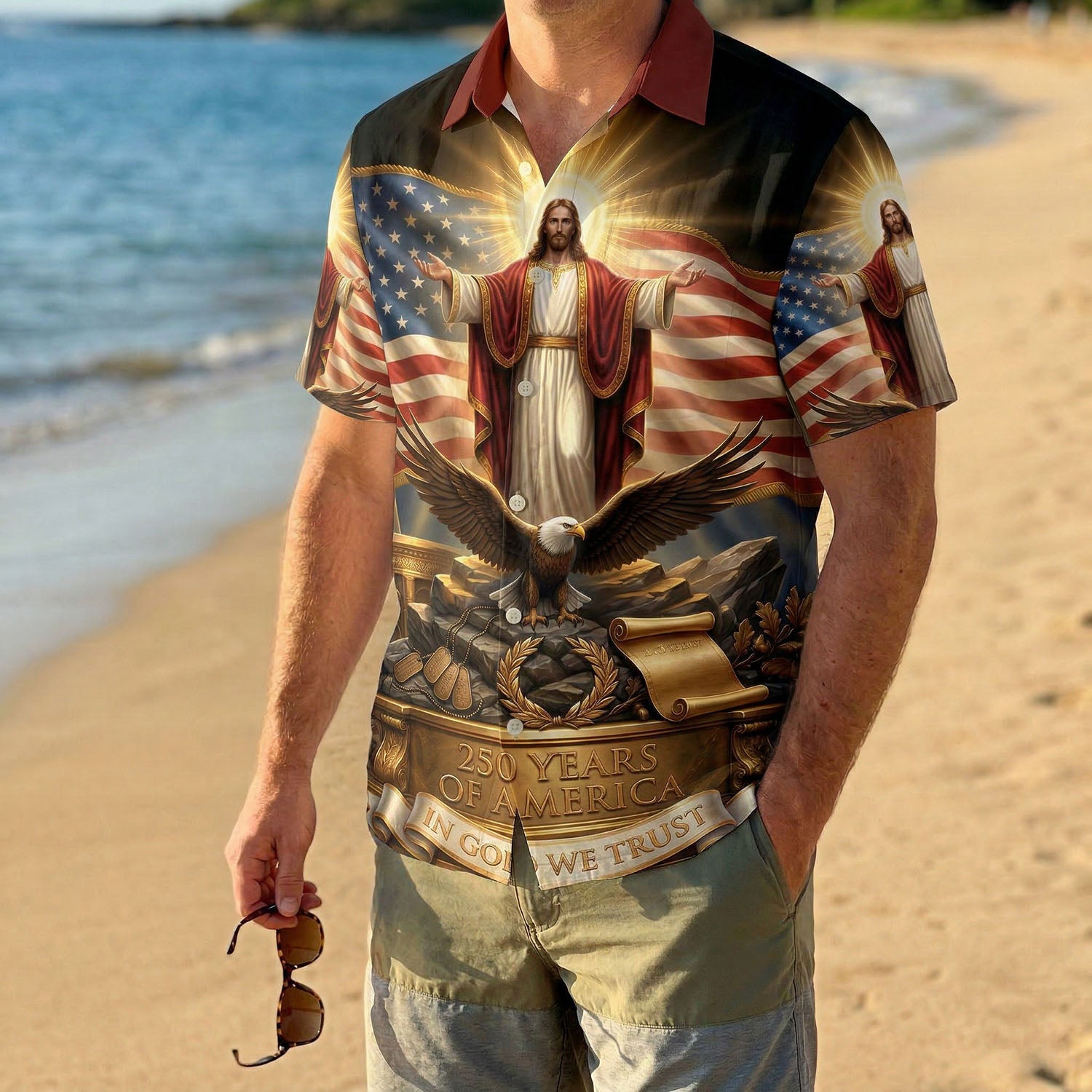 A male model wearing the vintage One Nation Under God Aloha shirt on a sunny beach, showcasing a meaningful and patriotic summer look.