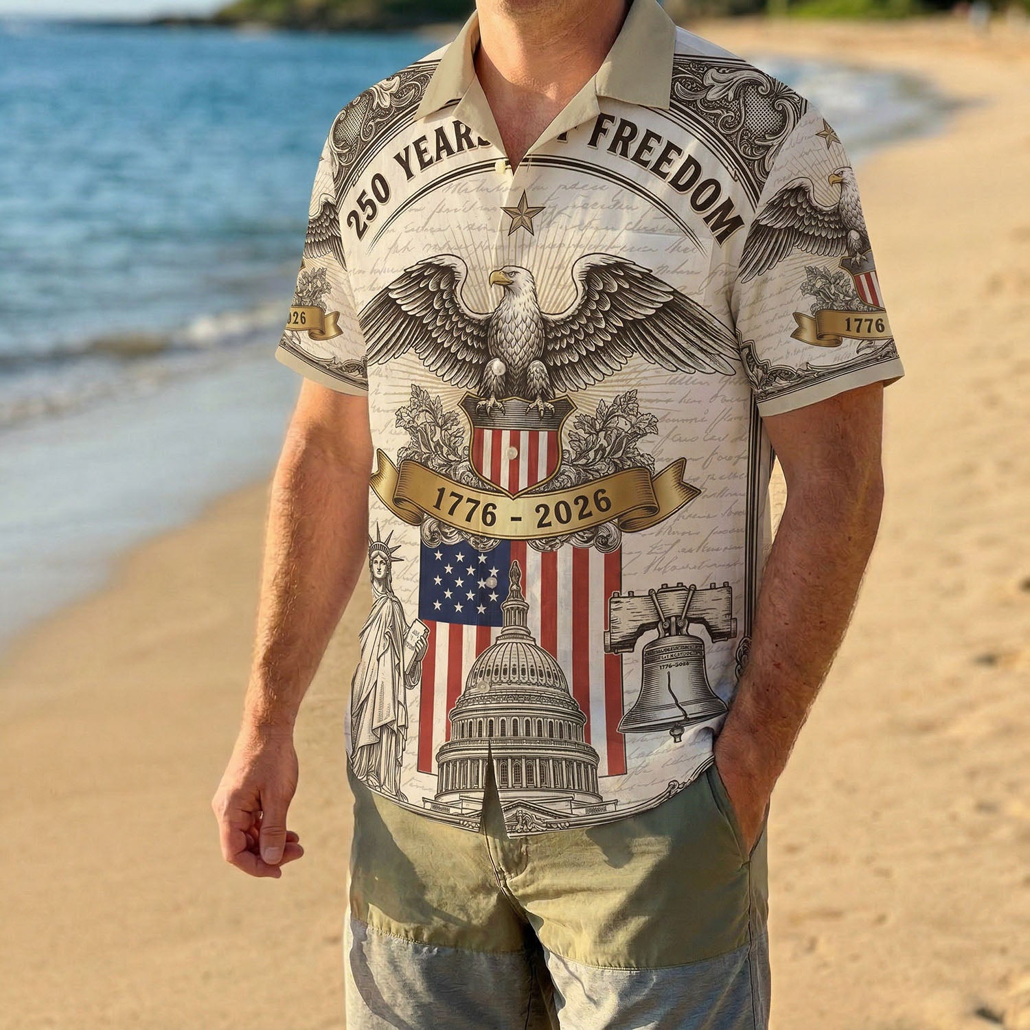 A male model wearing the 1776 2026 anniversary striped patriotic shirt on a sunny beach for a classic American summer look