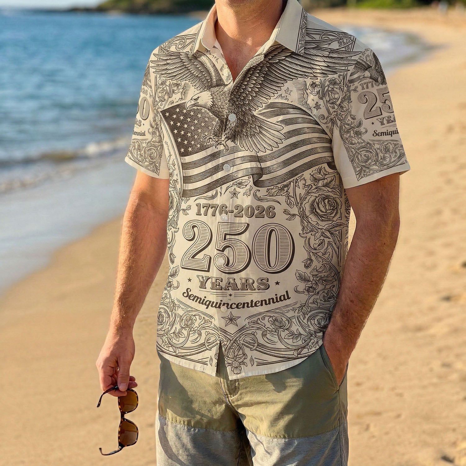 A male model wearing the vintage eagle 1776-2026 shirt on a sunny beach, showcasing a casual and patriotic summer look for the US anniversary.