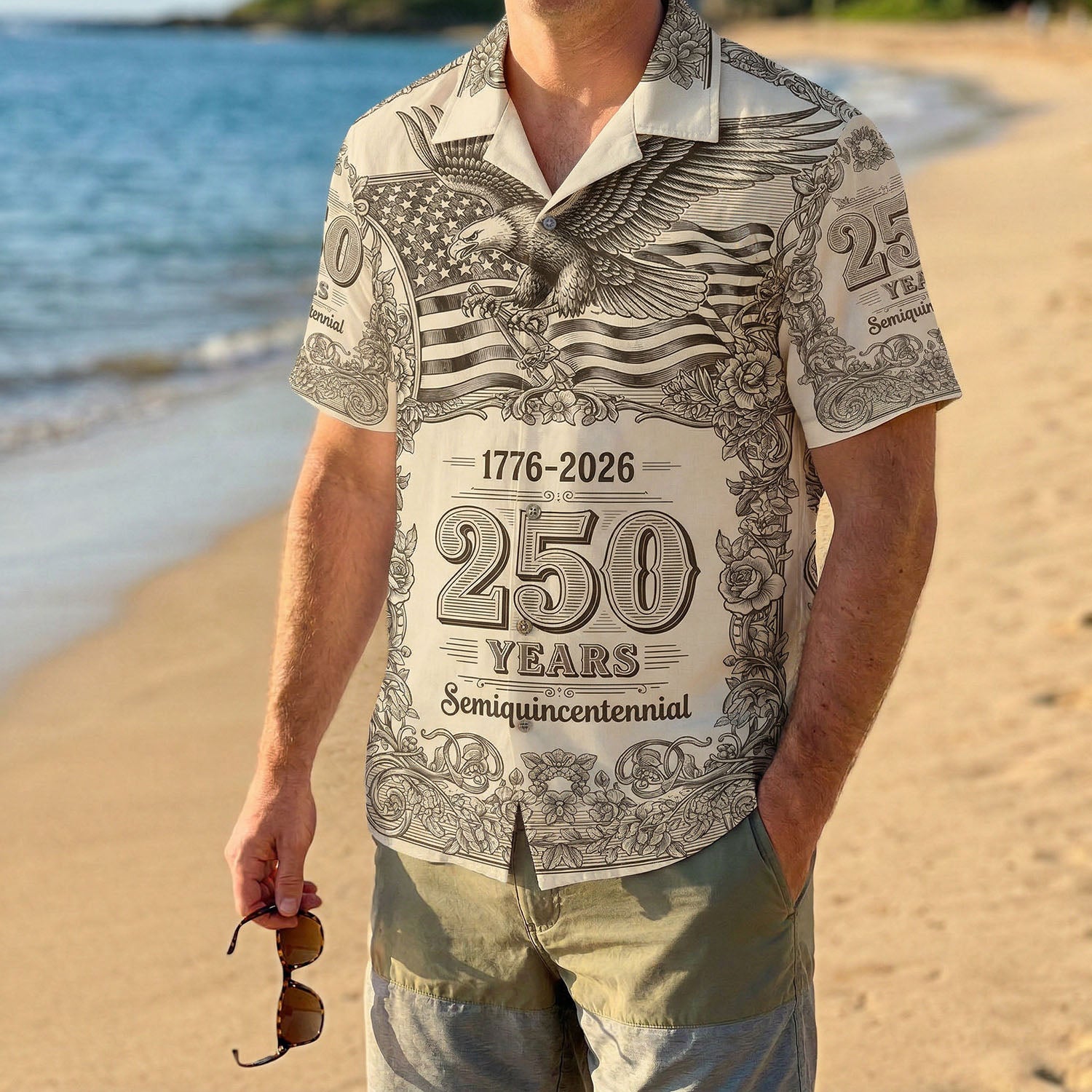 A male model wearing the vintage-style 1776-2026 American eagle shirt on a tropical beach, highlighting a casual and patriotic summer look.