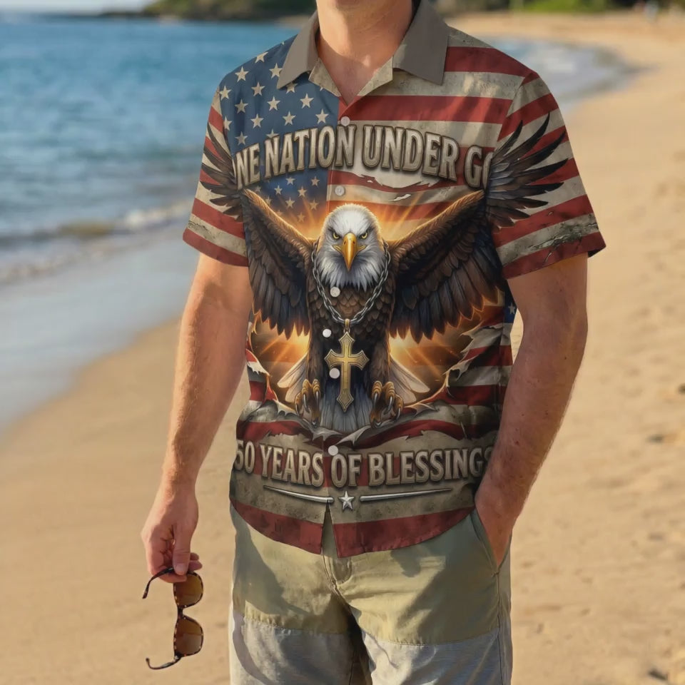 A man wearing the patriotic eagle and cross Hawaiian shirt on a beach, highlighting a sophisticated American summer look.