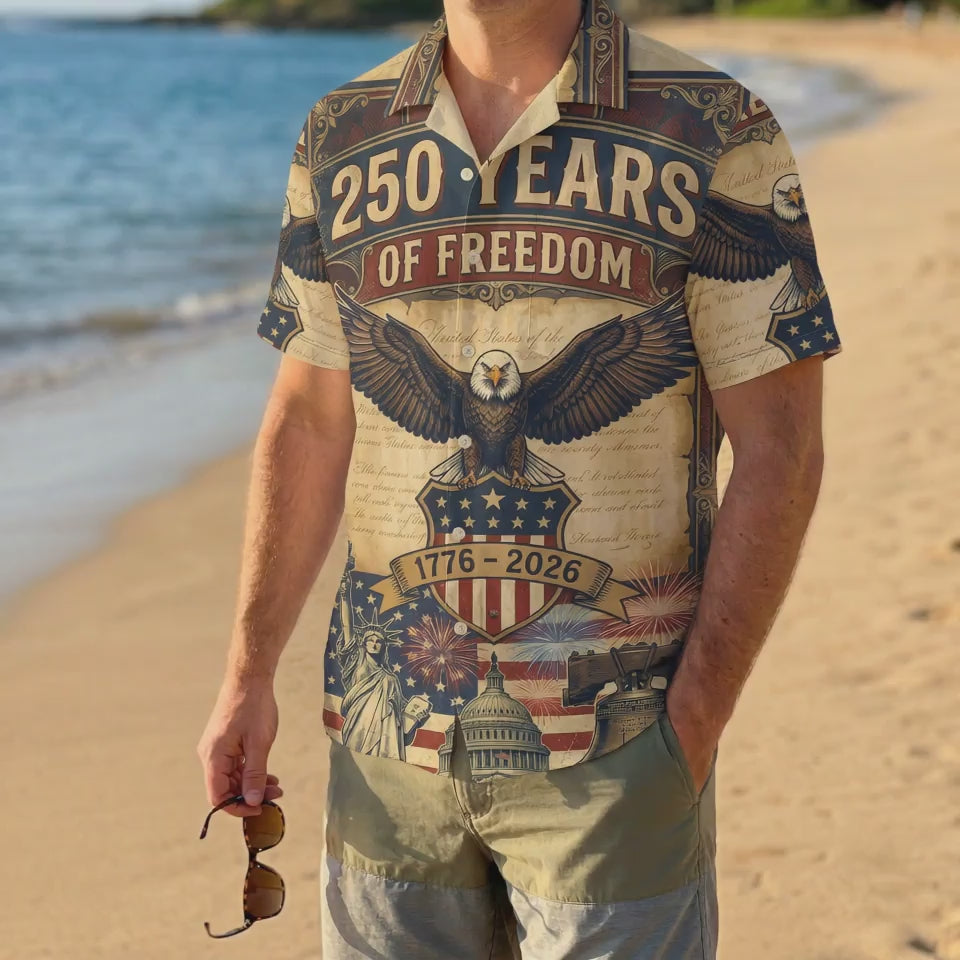 A male model wearing the white USA 250th anniversary patriotic shirt on a sunny beach showcasing a classic American summer look for the US birthday