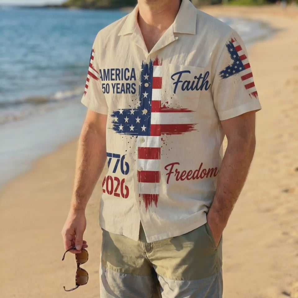 A man wearing the vintage cream Faith and Freedom shirt on a sunny beach, highlighting a sophisticated and meaningful patriotic summer look video