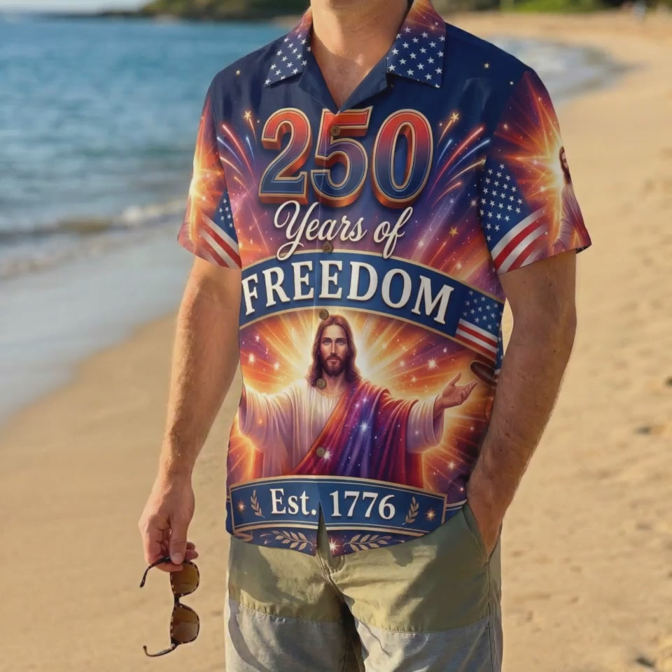 A man wearing the vibrant navy 250 years of freedom Jesus shirt on a beach, showcasing a festive patriotic summer look.