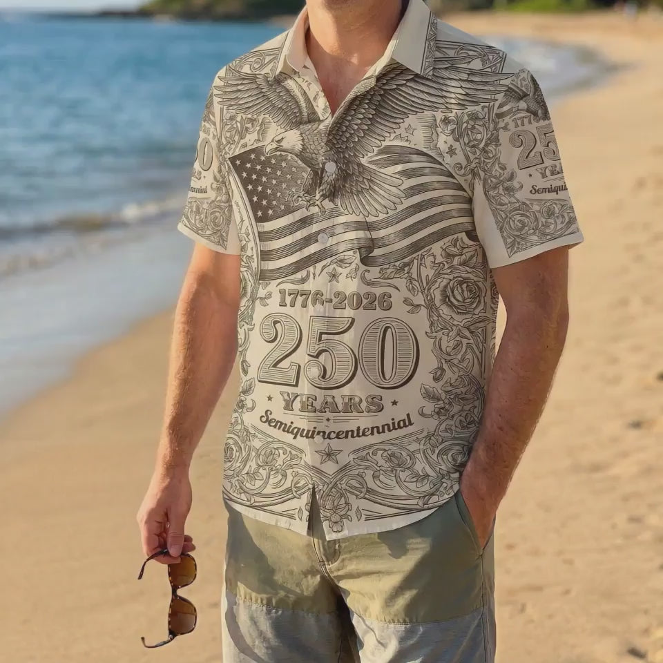 A male model wearing the vintage eagle 1776-2026 shirt on a sunny beach, showcasing a casual and patriotic summer look for the US anniversary.