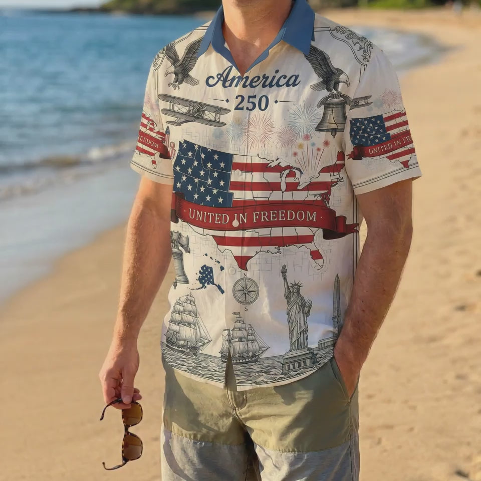 A male model wearing the vintage America 250 United In Freedom shirt on a sunny beach showcasing a casual patriotic summer outfit