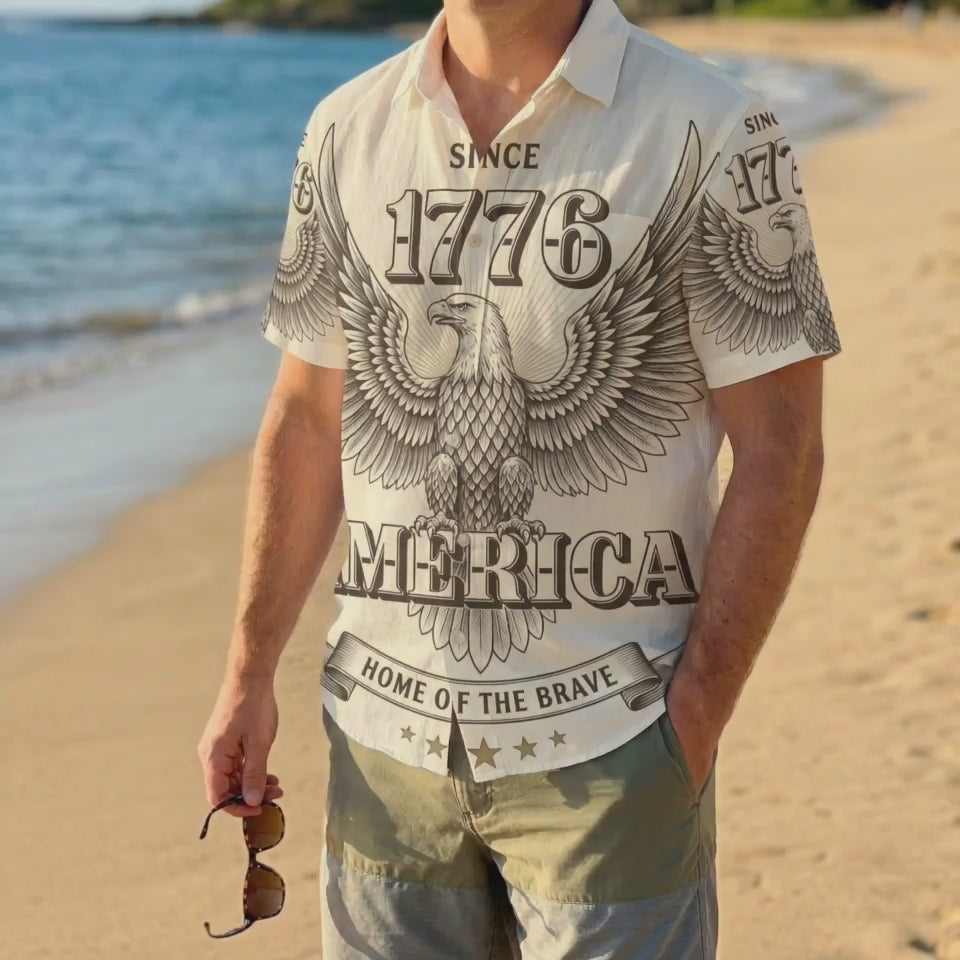 A man wearing the engraved eagle 1776 shirt on a beach, highlighting the sophisticated summer patriotic style.